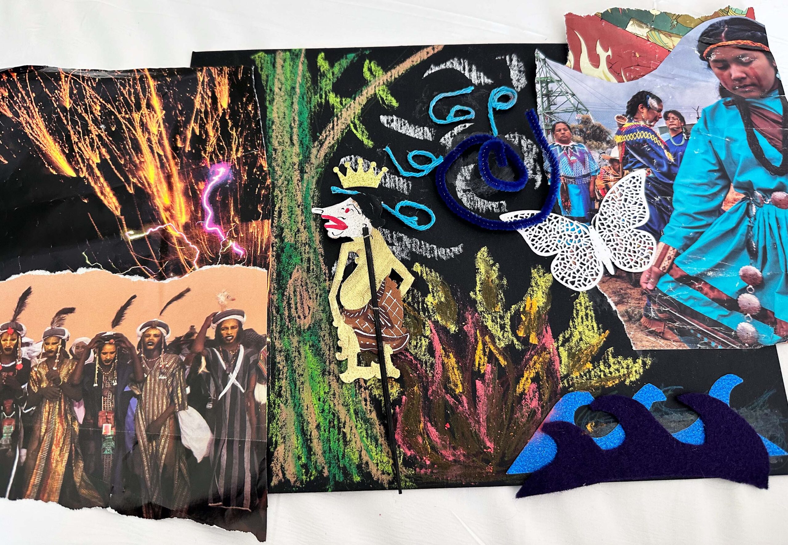 A collage image. In the background is a chalk drawing of a tree trunk with green branches. A fire burns next to the tree, with a dark brown flame that has pink, yellow, and orange highlights. A sun radiating white rays of light sits above the fire. At the center of the sun is a blue coil. A lacy white butterfly flies toward the sun. A Thai shadow puppet (in browns and yellows) is overlaid on this chalk drawing. To the left of the chalk image are two images that have been torn from magazines. On the top right is fireworks with plumes of white, and one streak of purple. On the bottom left is a group of North African men and women dressed in traditional garb with feathers in their headdress. On the top right is an image of an indigenous woman in a blue dress dancing. Below here are two felt waves, one light and one dark, that are placed one on top of the other.